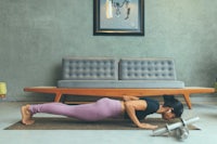a woman doing push ups in a living room
