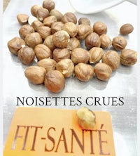 hazelnuts on a cutting board with the words noisettes crues