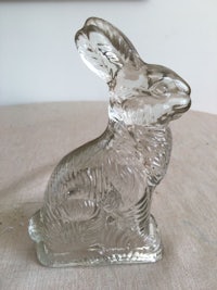 a glass rabbit sitting on top of a table