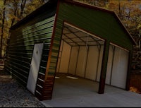 a green metal garage in the woods