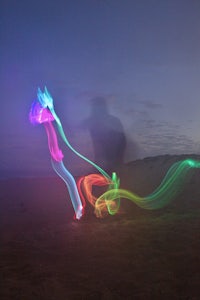 a light painting of a person on the beach