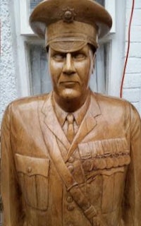 a wooden statue of a man in uniform