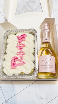 a box with a cake and a bottle of champagne