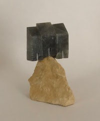 a small piece of quartz sitting on top of a rock