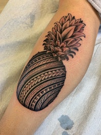 a tattoo of a pineapple on the leg