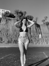 a black and white photo of a woman in a bikini