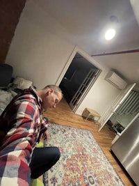 a man sitting on the floor in a living room
