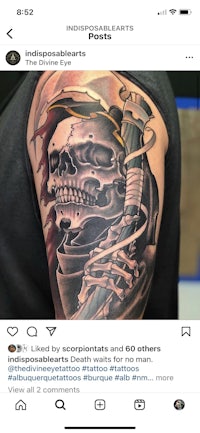 a tattoo of a skeleton with a sword