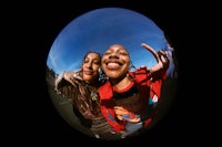 two women posing for a picture in a fish eye lens