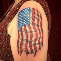 an american flag tattoo on a woman's arm