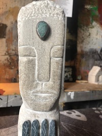 a statue with a green stone on it