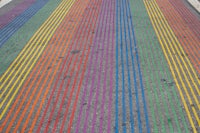 a street with a rainbow colored stripe