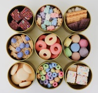 a group of tins filled with different kinds of candy