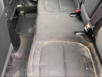 the back seat of a car with dirt on it