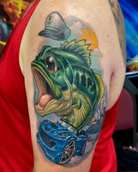a tattoo of a fish with a car on it