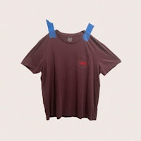 a brown t - shirt with blue tape on it