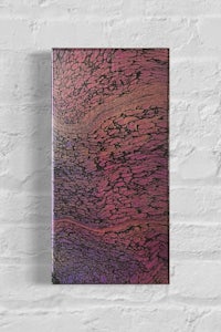 an abstract painting on a brick wall