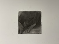a black and white drawing hanging on a wall