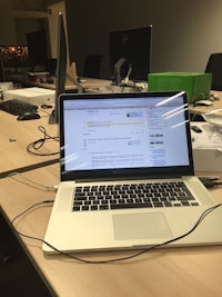 a laptop is sitting on a desk in an office