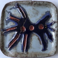 a ceramic plate with a blue and red design