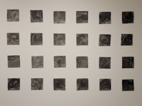 a group of black and white prints on a wall
