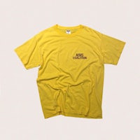 a yellow t - shirt with a red logo on it