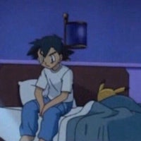 a boy is sitting on a bed in a pokemon cartoon