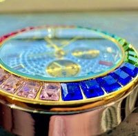 a watch with multi colored crystals on it