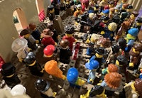 a large group of lego people in a room
