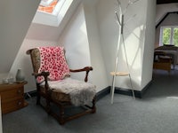 a chair in a room with a skylight