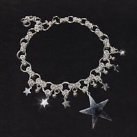 a silver star bracelet with silver charms