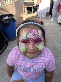 a little girl with face paint on her face