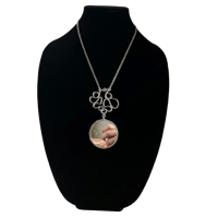 a necklace with a photo of a baby on it