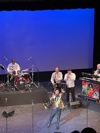 a group of people on stage with a band