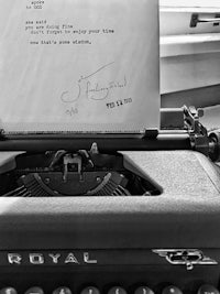a black and white photo of a typewriter with a letter on it