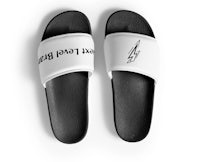 a pair of black and white slide sandals