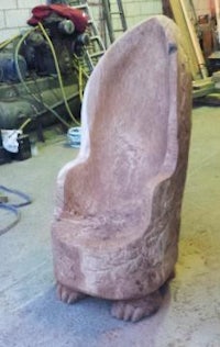 a chair made from a large rock in a workshop