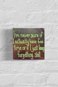 a brick wall with a quote that says i'm not sure if i actually have free time just forgetting shit
