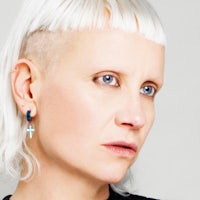 a woman with white hair and earrings