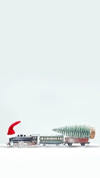 a toy train with a christmas tree and a santa hat