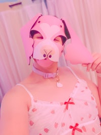 a woman wearing a pink dog mask