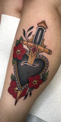 a tattoo of a heart with a sword on it