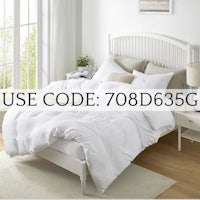 a bed in a room with a white duvet cover