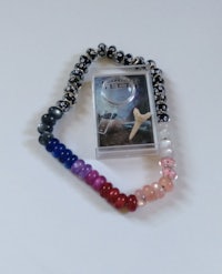 a bracelet with beads and a card on it