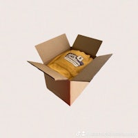 a cardboard box with a yellow t - shirt inside
