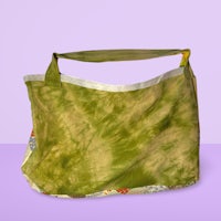 a green tote bag on a purple background