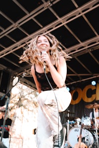 a woman on stage with dreadlocks
