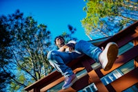 a man is sitting on the ledge of a house