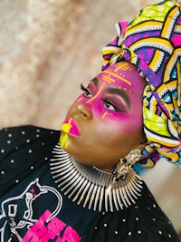 a woman wearing colorful makeup and a turban