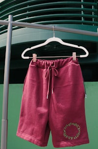 maroon sweat shorts hanging on a rack